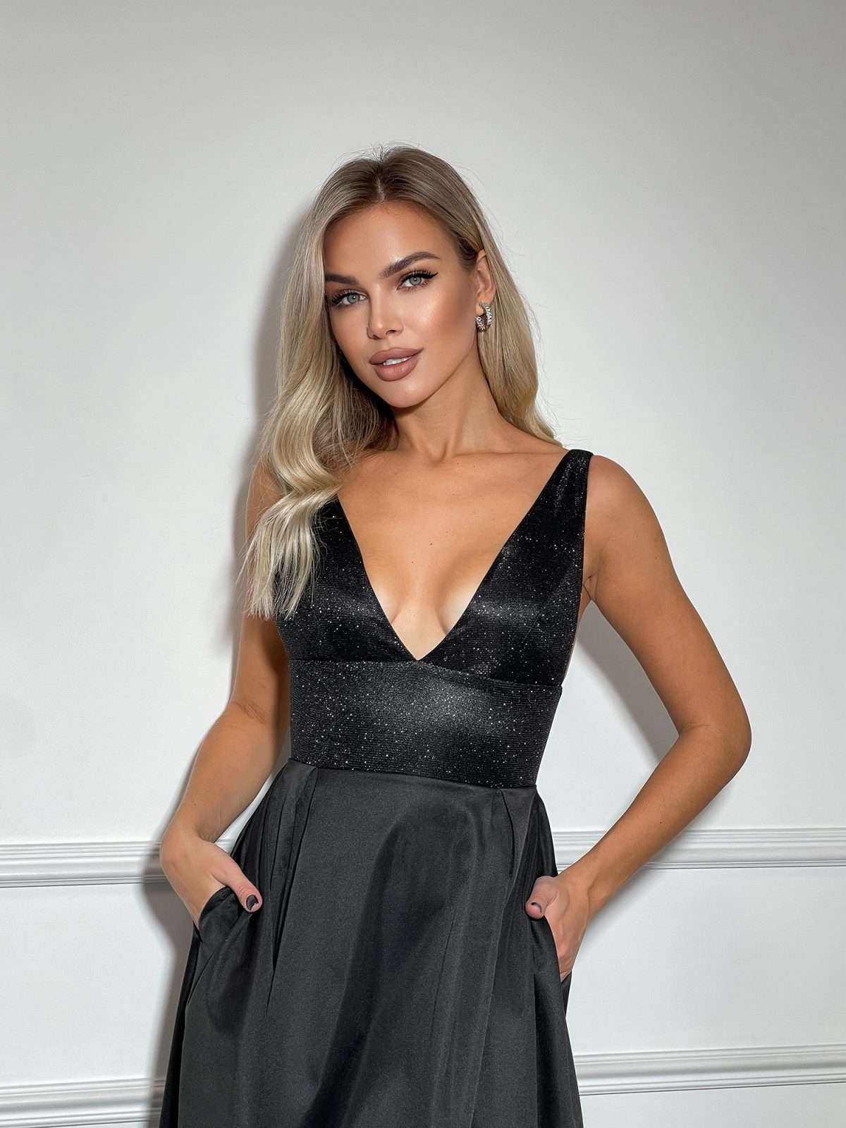 Sparkly Glitter Deep Neckline and Open Back Dress with High-Low Pleated Skirt and Pockets In Black - SHAWONÉ